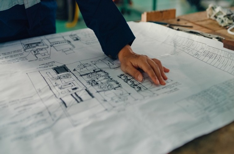 Technical engineer blueprint drawing on worktable
